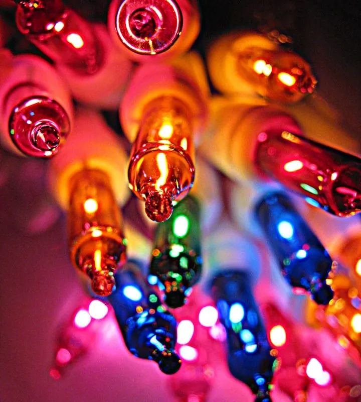 Macro close-up of a cluster of glowing pink, orange, blue, and green miniature light bulbs
