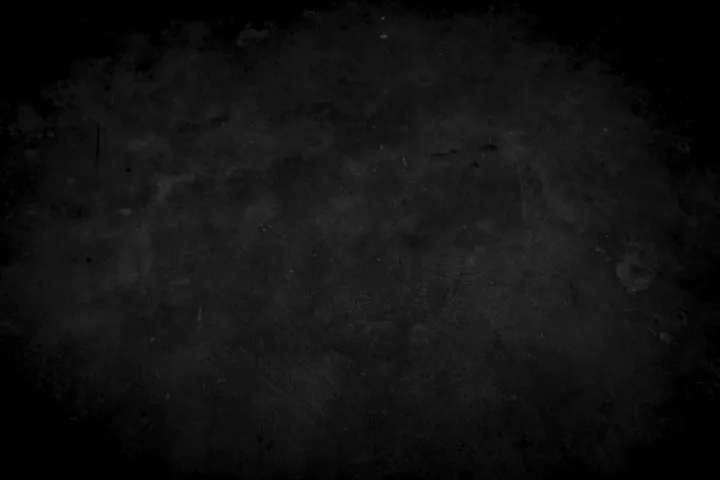 Close-up of a dark, grainy concrete or stone surface with a soft vignette